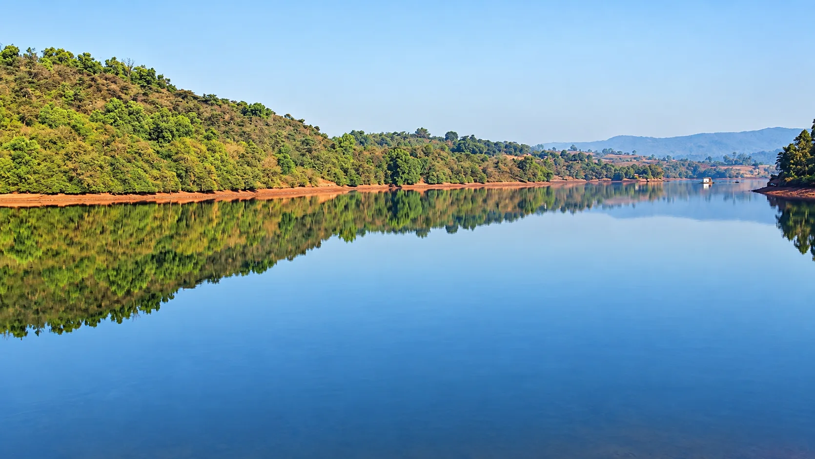 Hills rising behind Viva Andur lake view farmhouse near Gaganbawada