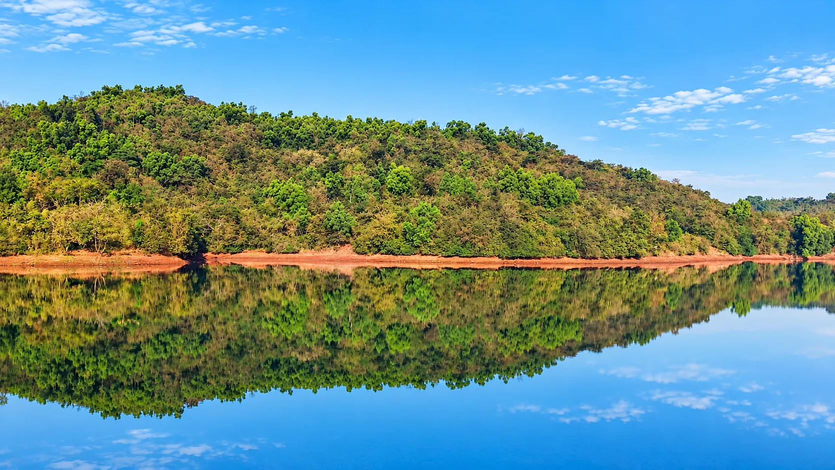 Hills rising behind Viva Andur lake view farmhouse