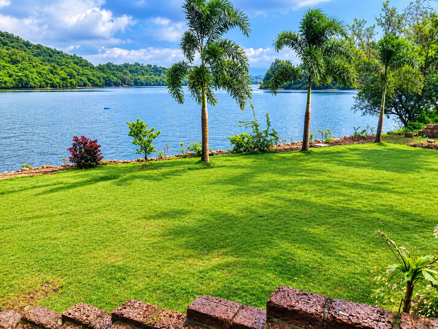Open lawn with lake view at Viva Andur farmhouse